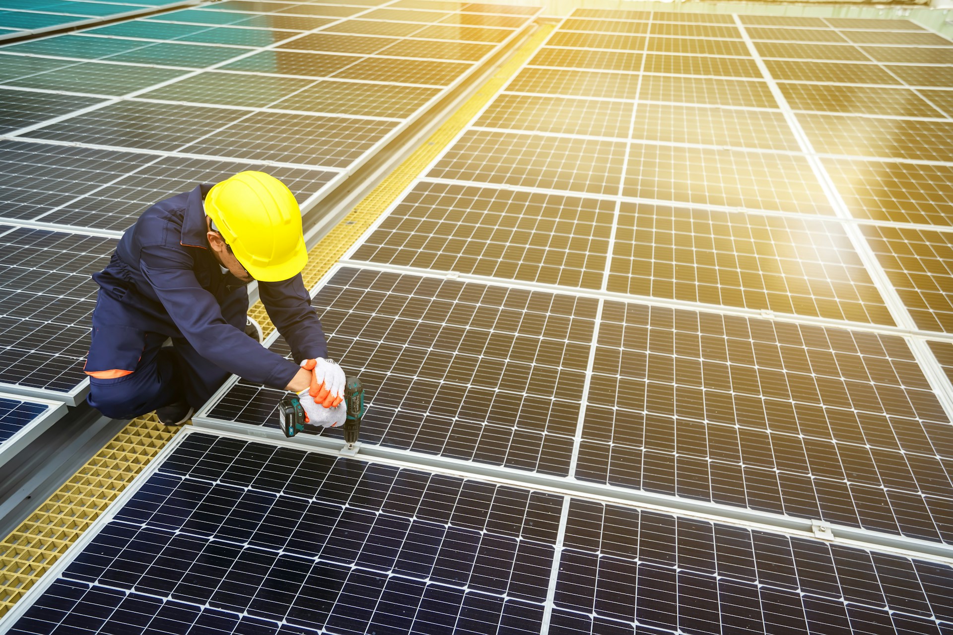 Solar energy technician working on solar panel installation